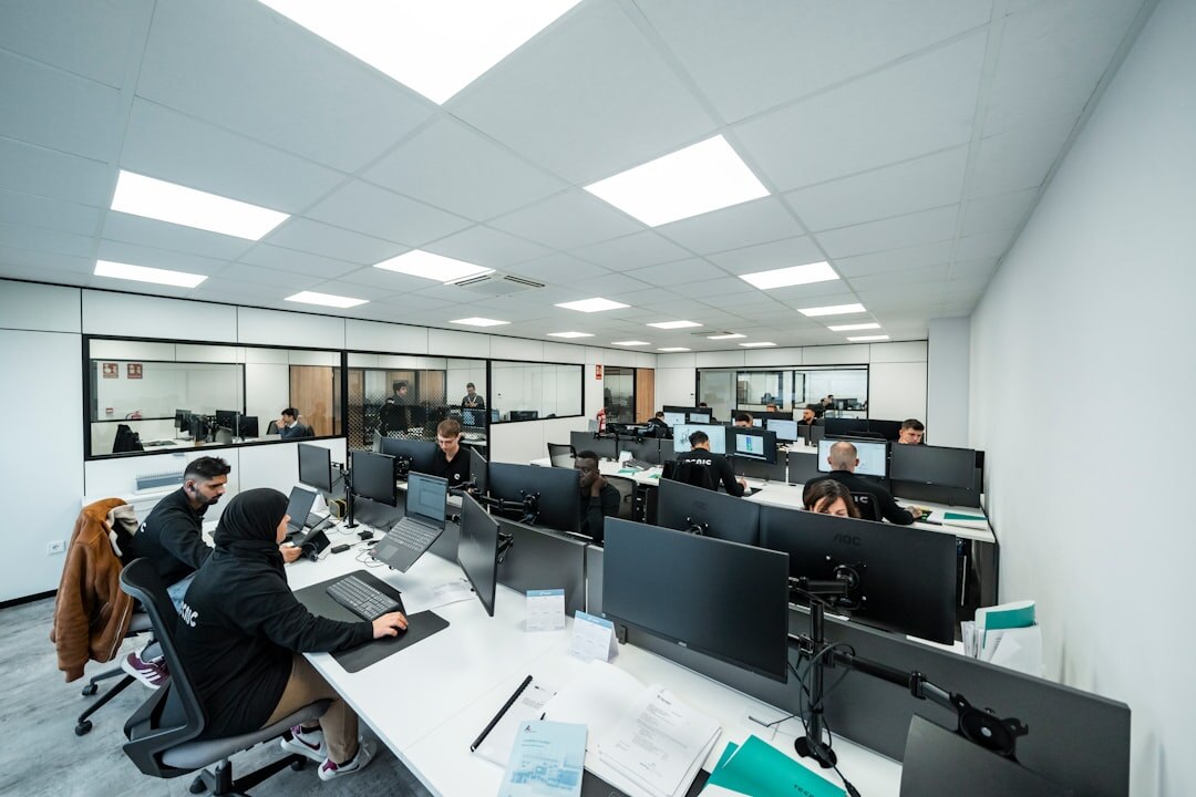 Modern newsroom office with people working at desks