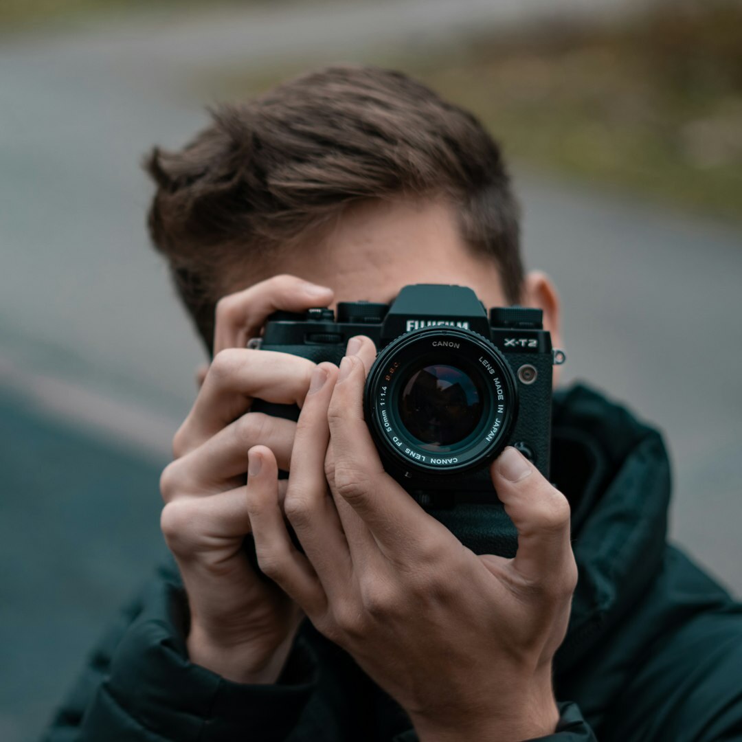 Photographer holding a camera at a red carpet event