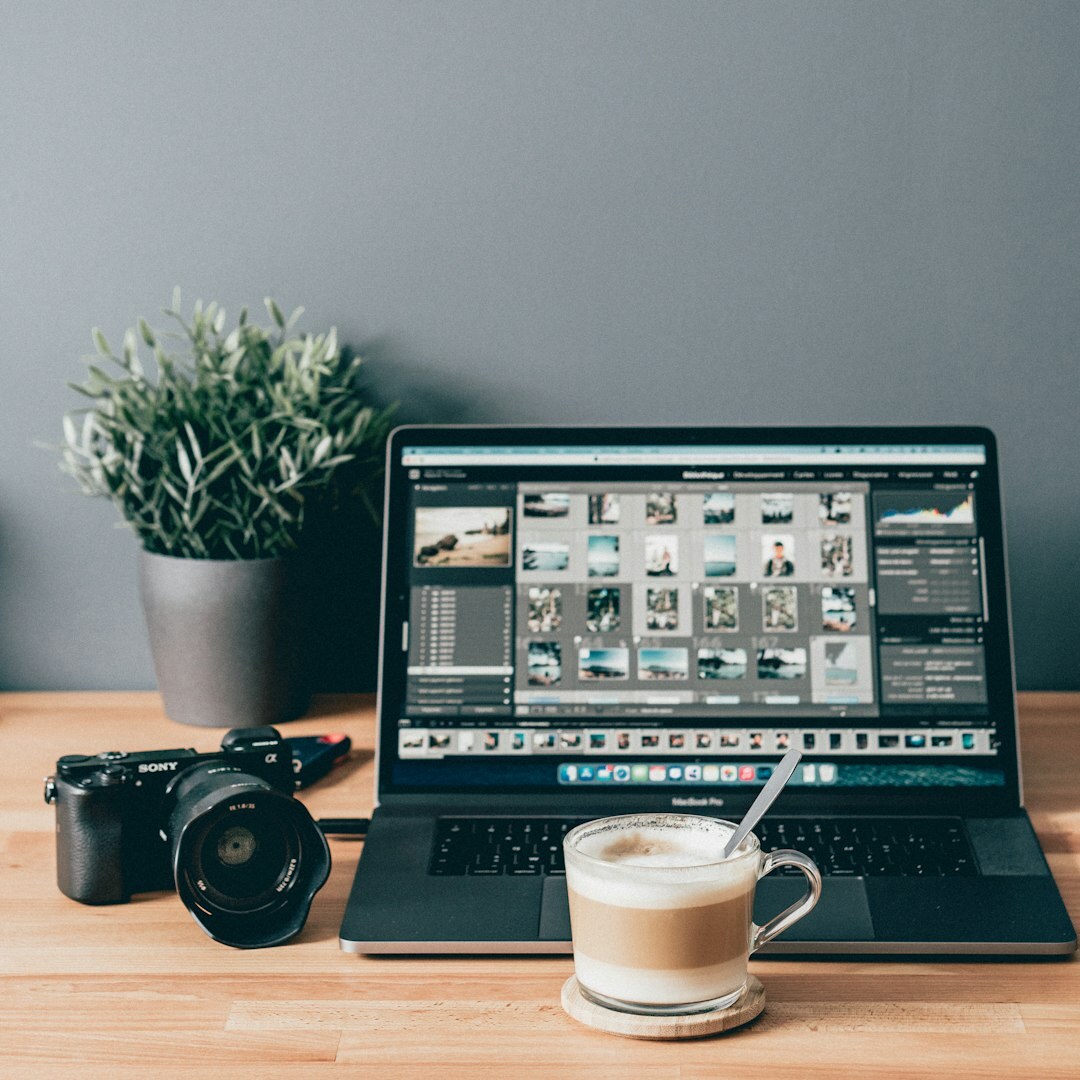 Editor working at a desk with a laptop and notes