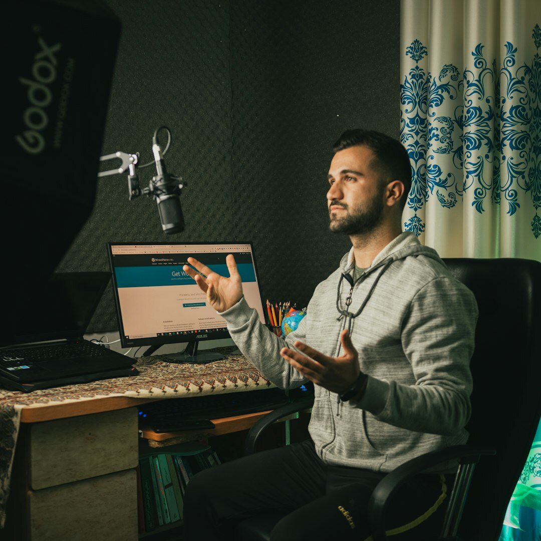 Television presenter speaking into a microphone in a studio
